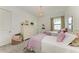 Charming bedroom with two twin beds, stylish decor, and ample natural light at 9048 Bernini Pl, Sarasota, FL 34240