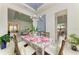 Light-filled dining room with table set for dinner and views into living room and kitchen at 9048 Bernini Pl, Sarasota, FL 34240