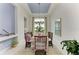 Light and airy dining room with chandelier, table set for dinner, and large window at 9048 Bernini Pl, Sarasota, FL 34240