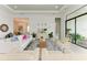 Bright living room with white furniture, plants, and large windows offering plenty of natural light at 9048 Bernini Pl, Sarasota, FL 34240