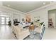Spacious living room boasts white seating, light tile floors, and elegant decor at 9048 Bernini Pl, Sarasota, FL 34240