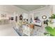 Bright, airy living room with white furniture, opening to the kitchen with bar stool seating at 9048 Bernini Pl, Sarasota, FL 34240