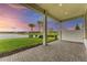 Covered patio with brick pavers and scenic lake views under a vibrant sky at 9048 Bernini Pl, Sarasota, FL 34240
