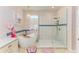 This bathroom features a modern tub, a large shower, and a decorative chandelier at 11306 77Th E St, Parrish, FL 34219