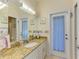 Bathroom featuring a large mirror, a granite countertop, and modern fixtures at 11306 77Th E St, Parrish, FL 34219