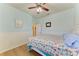 A calming bedroom with nautical themed decor, light blue walls, and wood floors at 11306 77Th E St, Parrish, FL 34219