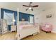 Bright bedroom featuring a four-poster bed, wood floors and complementary colors and accents at 11306 77Th E St, Parrish, FL 34219