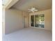 Covered outdoor patio features a ceiling fan and seamless access to the pool area through sliding glass doors at 11306 77Th E St, Parrish, FL 34219