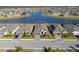 A lovely aerial view of a single-Gathering home in a lakeside community at 1889 Saddlewood Cir, Port Charlotte, FL 33953