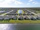 Aerial view of the property highlighting its lakefront location and neighborhood setting with well-maintained lawns at 1889 Saddlewood Cir, Port Charlotte, FL 33953