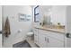Bright bathroom with granite countertop vanity, framed art, and a large window for natural light at 1889 Saddlewood Cir, Port Charlotte, FL 33953