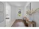 Bright entryway with tile floors, console table with decor, and a view into the bedroom at 1889 Saddlewood Cir, Port Charlotte, FL 33953
