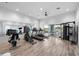 Community gym features modern equipment and a view of outdoor seating and palm trees at 1889 Saddlewood Cir, Port Charlotte, FL 33953