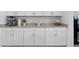 Clean kitchen countertop with stainless steel appliances and ample storage in white cabinetry at 1889 Saddlewood Cir, Port Charlotte, FL 33953