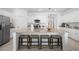 Spacious kitchen island with granite countertops, seating for four, and modern stainless steel appliances at 1889 Saddlewood Cir, Port Charlotte, FL 33953