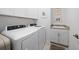 Functional laundry room includes front loading washer and dryer, upper cabinets, and a utility sink at 1889 Saddlewood Cir, Port Charlotte, FL 33953