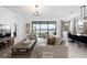 Bright living room with neutral tones, elegant furnishings, and a view of the lake at 1889 Saddlewood Cir, Port Charlotte, FL 33953