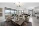 Open-concept living room with modern decor, dining area, and sliding glass doors to a patio at 1889 Saddlewood Cir, Port Charlotte, FL 33953