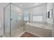 Modern bathroom featuring a glass walk-in shower and a soaking tub with a view at 1889 Saddlewood Cir, Port Charlotte, FL 33953