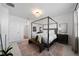 Spacious main bedroom with a canopy bed, neutral palette, and stylish furnishings at 1889 Saddlewood Cir, Port Charlotte, FL 33953
