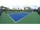 Multiple blue and green pickleball courts with black fencing, surrounded by palm trees at 1889 Saddlewood Cir, Port Charlotte, FL 33953
