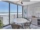 Bright dining area featuring stylish wicker chairs, coastal decor, and panoramic ocean views at 20 Whispering Sands Dr # 306, Sarasota, FL 34242