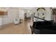 Open living room with hardwood floors, piano, and dining area in a bright space at 2173 Muskogee Trl, Nokomis, FL 34275