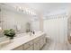 Bright bathroom featuring white tiling, a large mirror, and a shower with a curtain at 2721 12Th St, Englewood, FL 34224