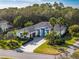 Expansive aerial view of a well-manicured property, featuring a lush green landscape and winding brick driveway at 3407 155Th E Ave, Parrish, FL 34219