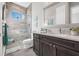 Modern bathroom featuring a glass-enclosed shower, dark wood vanity, and neutral decor at 3407 155Th E Ave, Parrish, FL 34219
