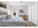 Bright bedroom showcasing neutral walls, closet doors, and a window at 3407 155Th E Ave, Parrish, FL 34219