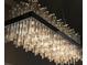Close up of chandelier with black base and hanging glass columns at 3407 155Th E Ave, Parrish, FL 34219