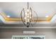 A modern, globe chandelier hangs from a tray ceiling with recessed lighting at 3407 155Th E Ave, Parrish, FL 34219