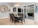 Dining area with stylish table, chairs, modern light fixture, and sliding glass doors to backyard at 3407 155Th E Ave, Parrish, FL 34219