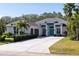Beautiful exterior elevation of a home featuring a brick driveway, two-car garage, and blue door at 3407 155Th E Ave, Parrish, FL 34219