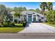 Beautiful single-Gathering home with a vibrant blue front door, lush landscaping and a paver driveway at 3407 155Th E Ave, Parrish, FL 34219