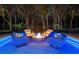 Outdoor patio with comfortable seating around a modern fire pit featuring LED lighting for evening enjoyment at 3407 155Th E Ave, Parrish, FL 34219