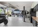 Spacious garage featuring a car lift, golf cart, and ample storage cabinets at 3407 155Th E Ave, Parrish, FL 34219