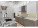 Bright kitchen featuring stainless steel appliances, mosaic tile backsplash, granite countertops, and custom cabinets at 3407 155Th E Ave, Parrish, FL 34219