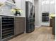 Kitchen with a stainless steel refrigerator, wine cooler, granite countertop, and white cabinets at 3407 155Th E Ave, Parrish, FL 34219