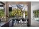 Outdoor bar area with pool view featuring a granite bar, barstools, and convenient access to outdoor amenities at 3407 155Th E Ave, Parrish, FL 34219
