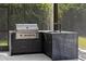 Outdoor kitchen with stainless steel grill and granite countertop at 3407 155Th E Ave, Parrish, FL 34219