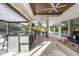 Bright outdoor living space with a bar, grill, and comfortable seating overlooking the lush backyard at 3407 155Th E Ave, Parrish, FL 34219