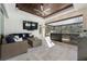 The outdoor living space features a comfortable seating area, bar, grill, and beautiful wood ceiling detail at 3407 155Th E Ave, Parrish, FL 34219