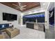 This bright outdoor living space features a seating area, bar, grill, and elegant lighting at 3407 155Th E Ave, Parrish, FL 34219