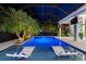 Inviting pool area features lit-up pool, sun loungers, adjacent patio, and lush tropical landscaping at 3407 155Th E Ave, Parrish, FL 34219
