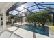 Inviting screened pool area with lounge chairs and lush tropical landscaping at 3407 155Th E Ave, Parrish, FL 34219