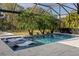 Beautiful screened-in pool with sun shelves, palm trees, and outdoor lounging space for relaxation at 3407 155Th E Ave, Parrish, FL 34219