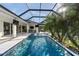 Full view of the screened pool area highlighting lounge chairs and outdoor kitchen at 3407 155Th E Ave, Parrish, FL 34219