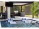 Outdoor pool area features a covered bar, grill, and in-water lounge chairs at 3407 155Th E Ave, Parrish, FL 34219